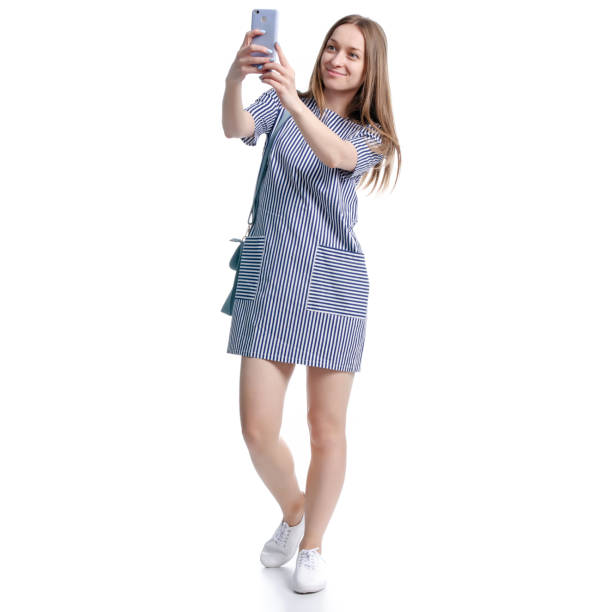istock Woman in blue dress making selfie 1140626378