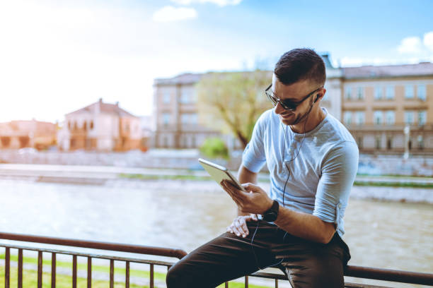 istock Listening to music by the river 1140626944