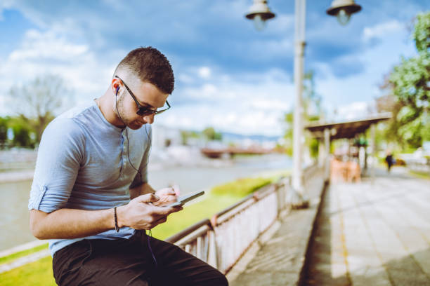 istock Listening to music by the river 1140627594