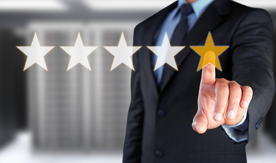 Businessman touching five star symbol to increase rating of company