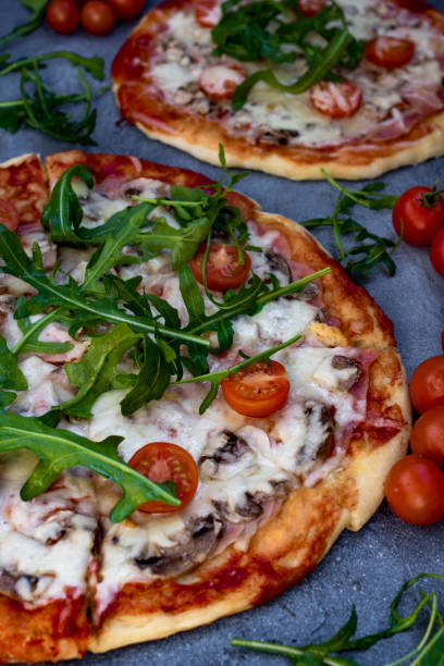 istock Homemade pizza with rucola and cherry tomatoes. 1140628183