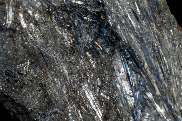 istock Macro of a stone Stibnite mineral on a black background 1140629070