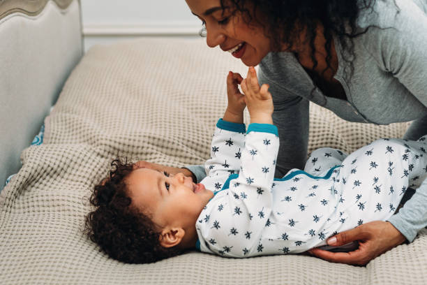 istock Mom and baby boy playing on the bed 1140632343