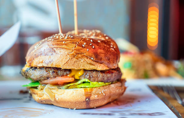 istock Eating hamburger with French fries chips 1140635724