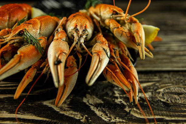 istock Boiled crayfish on a rough wooden background 1140637590