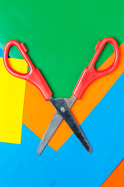 istock Scissors lie on multicolor paper. Green, Orange, Yellow, Blue 1140637648