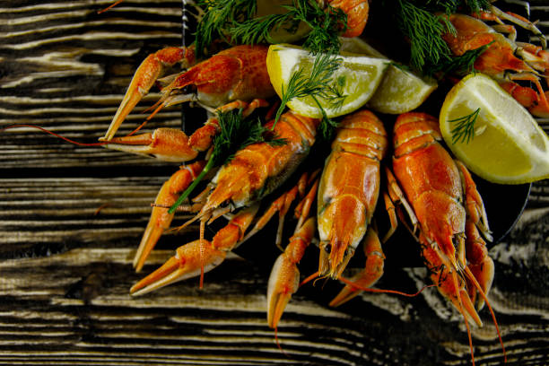 istock Boiled crayfish on a rough wooden background 1140637674