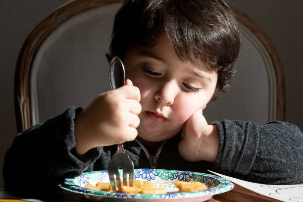 istock Smiling three years old child boy having lunch 1140637698