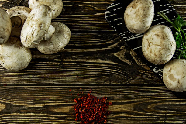 istock Fresh mushrooms with spices on a rough wooden background 1140638529