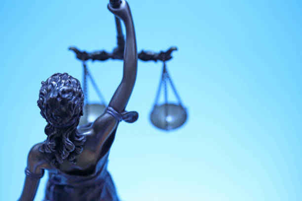 istock Statue Of Lady Justice On Blue Background 1140641346