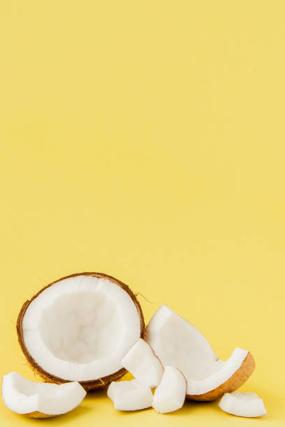 istock close up fresh coconut pieces isolated on a yellow background, tropical fruit concept, flat lay, pop art, copy space 1140643037