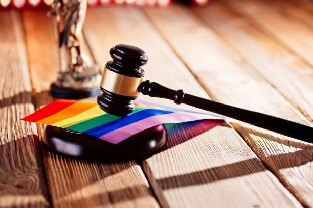 Judge wooden mallet - symbol of law and justice with lgbt rainbow colours flag stock photo