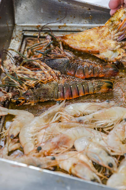 istock Preparing lobsters and shrimps - vertical 1140646082