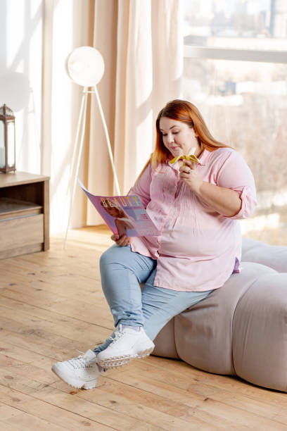 istock Positive nice woman reading an article about beauty 1140647345
