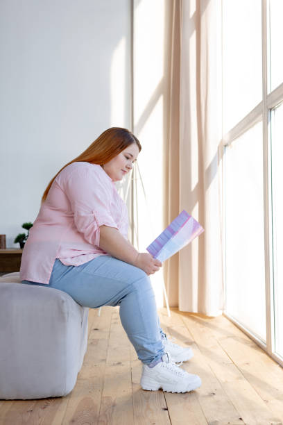 istock Nice pretty woman sitting near the window 1140647356
