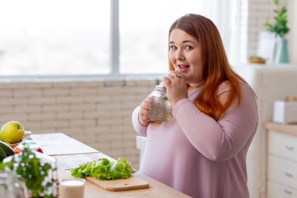 istock Positive nice woman having a healthy beverage 1140647410