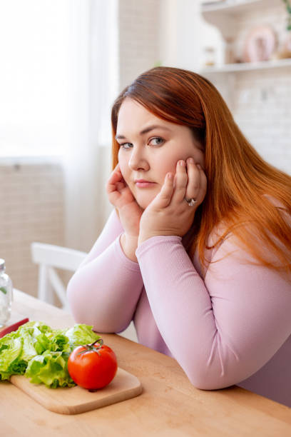 istock Cheerless plump woman thinking about her diet 1140647434