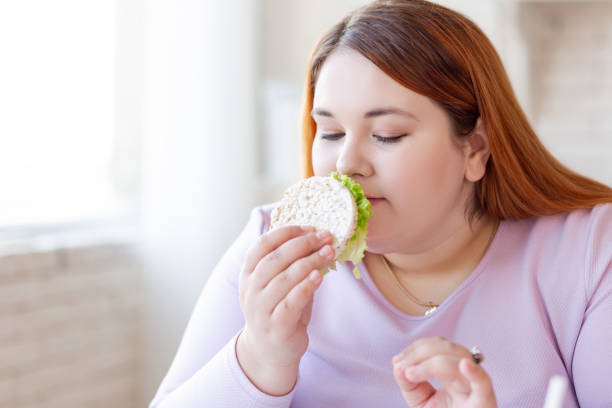 istock Good looking hungry woman smelling a sandwich 1140647453