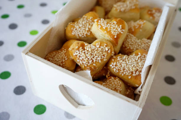 Snack salty cookies in shape of heart with organic sesame in the decorative wooden box