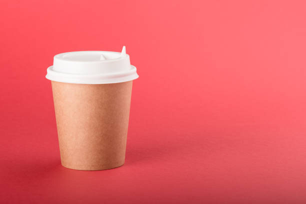 istock Kraft disposable cup with white cap on a red background 1140651140