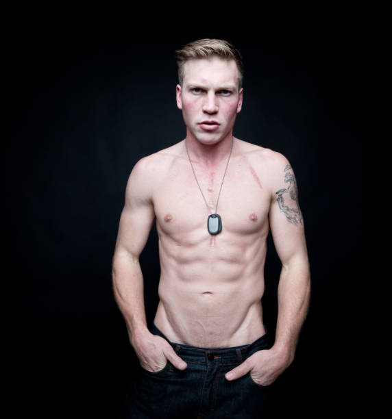 istock Handsome shirtless man wearing a dogtag 1140651161