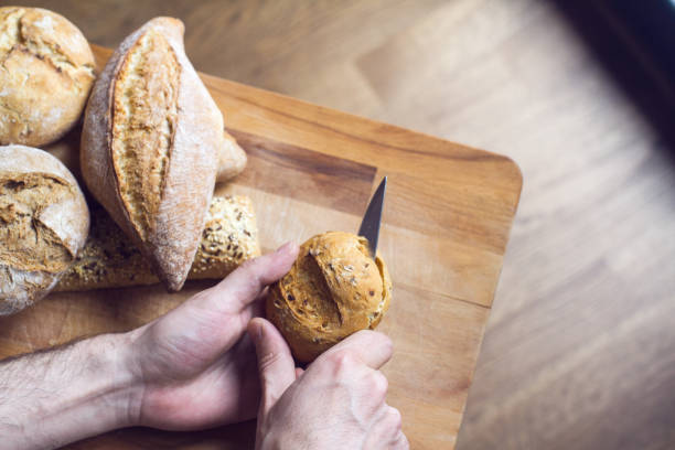 istock Caucasian male cutting bread 1140653887