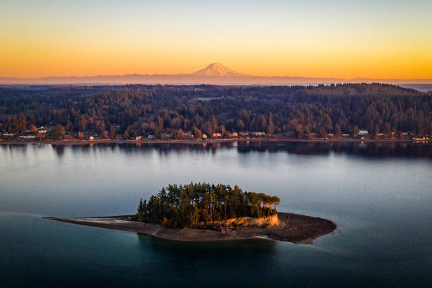 Aerial View Above Cutts Island AKA Deadmans Island Puget Sound WA An aerial view of Cutts Island with Mt Rainier in the background at golden hour Puget Sound Washington puget sound stock pictures, royalty-free photos & images