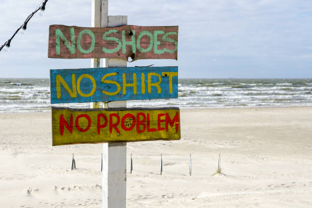 colorful inscription at the beach cafe, no problem colorful inscription at the beach cafe, no shoes, no shirt, no problems no brainer sign stock pictures, royalty-free photos & images
