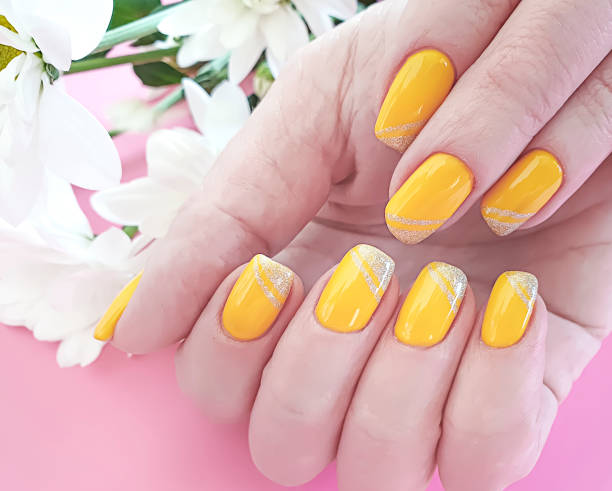 istock female hands manicure, chrysanthemum flower on a colored background 1140657275