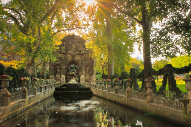 Medici fountain at sunrise - Luxembourg gardens – Paris, France The Medici Fountain (fr: La fontaine Médicis) is a monumental fountain in the Jardin du Luxembourg in the 6th arrondissement in Paris. It was built in about 1630 by Marie de' Medici, the widow of King Henry IV of France and regent of King Louis XIII of France. It was moved to its present location and extensively rebuilt in 1864-66. luxembourg paris stock pictures, royalty-free photos & images