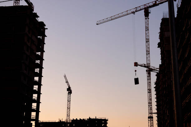 istock construction of the building cranes in the strongest light, otherwise 1140662820