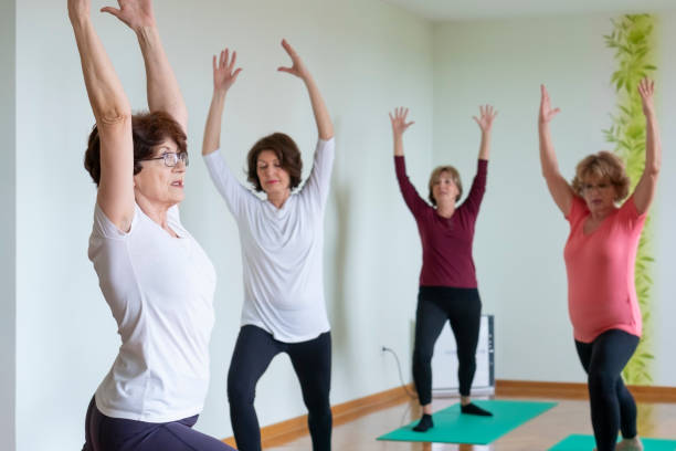 istock Senior women practicing  yoga in yoga studio 1140662853