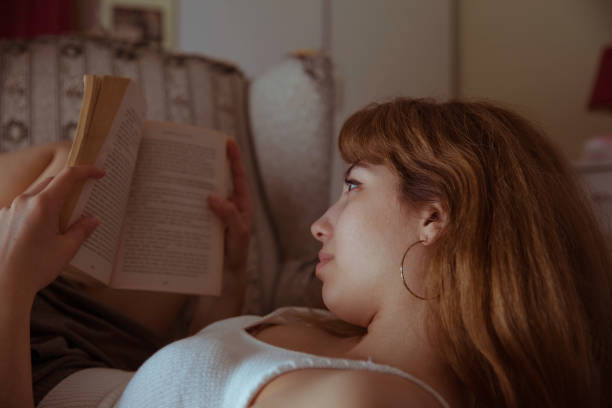 istock Beautiful woman reading book 1140664153