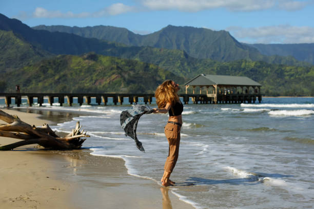 mid-age women express herself with joy and happiness, surrounded by TROPICAL Hawaiian landscape
