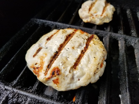 Close-up of turkey burgers on a grill with grill marks, April 3, 2019