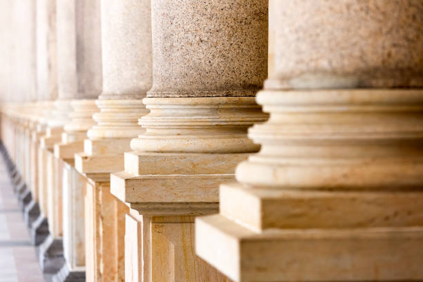 istock Colonnade, row of classical stone columns, background with copy spaced 1140671512