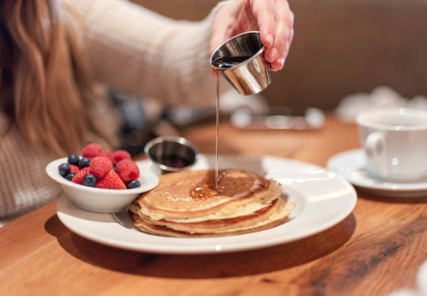 istock Pouring warm maple syrup on pancakes 1140671541