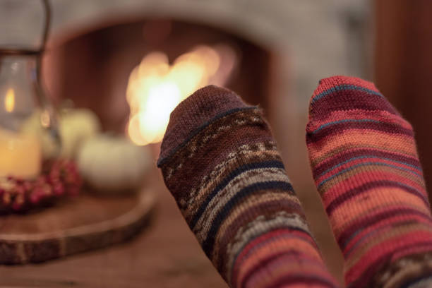 istock Relaxing by the cozy fire in colorful hand knit socks 1140672480