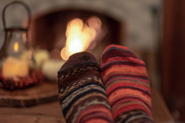 Snuggling up by the fireplace with feet up