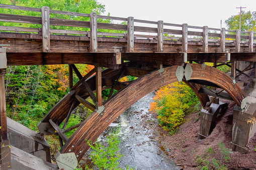 Timber bridge over scenic river in autumn