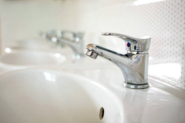 istock Water faucets with white sinks in the bathroom 1140676357