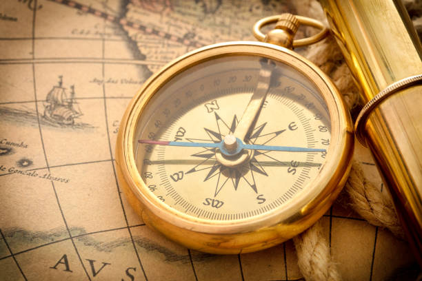 istock antique compass, magnifier, spyglass on map 1140679149