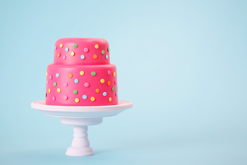 Cheerful spotted pink cake with copy space.