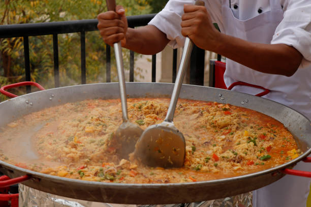 istock chef cooking Spanish paella in outdoor area 1140681086