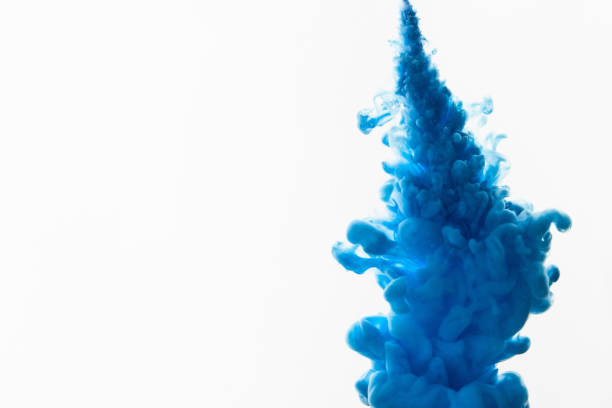 spraying abstract acrylic paint - blue ink imagens e fotografias de stock