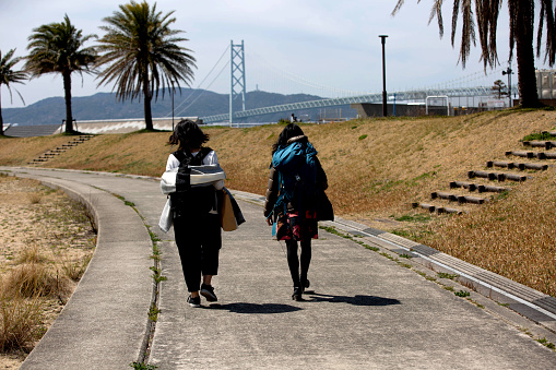 Two women walking while traveling