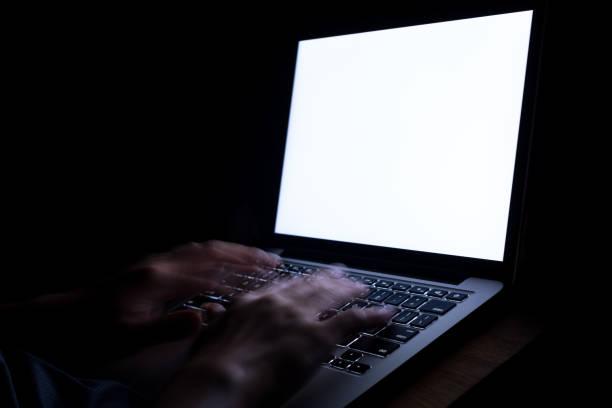 istock A man hand using laptop with blank screen at night. bedtime working concept. 1140693150