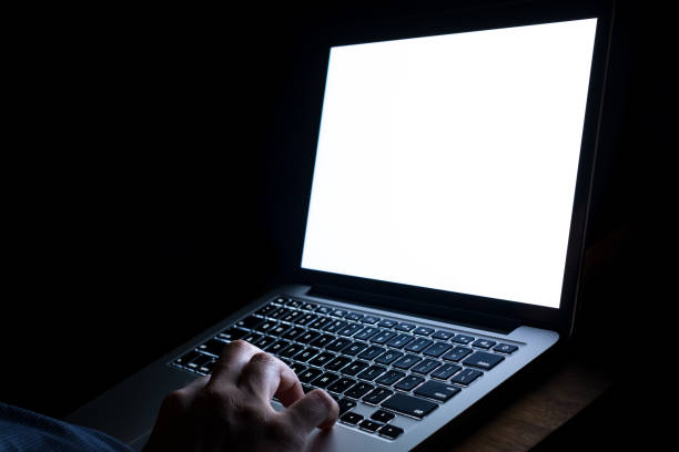 istock A man hand using laptop with blank screen at night. bedtime working concept. 1140693155