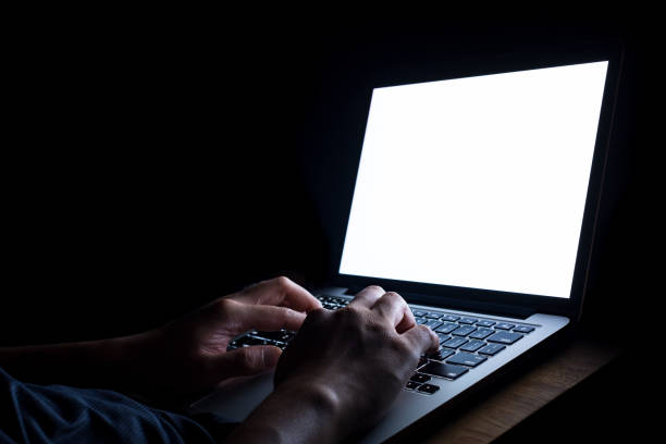 istock A man hand using laptop with blank screen at night. bedtime working concept. 1140693160