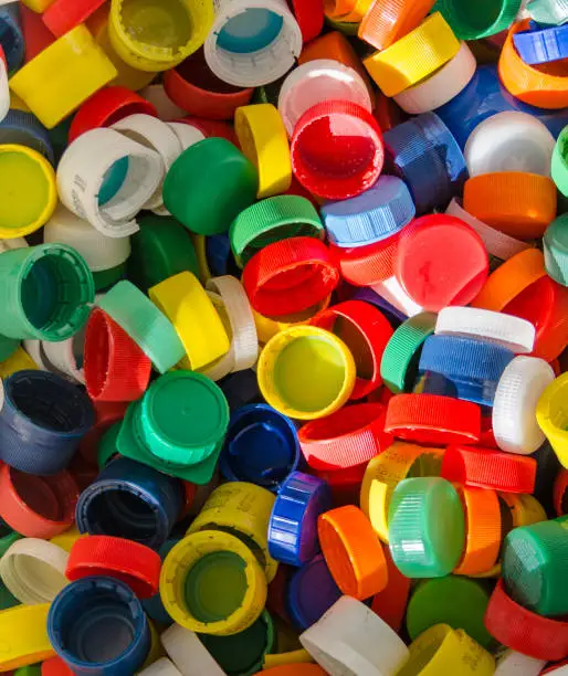 Colorful plastic bottlecaps closeup. Recycling and industry  concept.